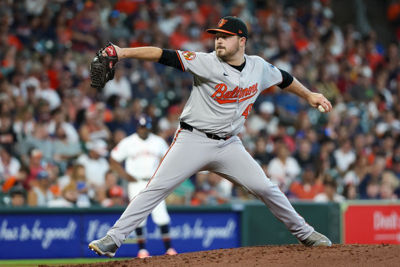 Jun 23, 2024; Houston, Texas, USA; Baltimore Orioles relief pitcher Keegan Akin (45) pitches against the Houston Astros in the seventh inning at Minute Maid Park. Mandatory Credit: Thomas Shea-USA TODAY Sports