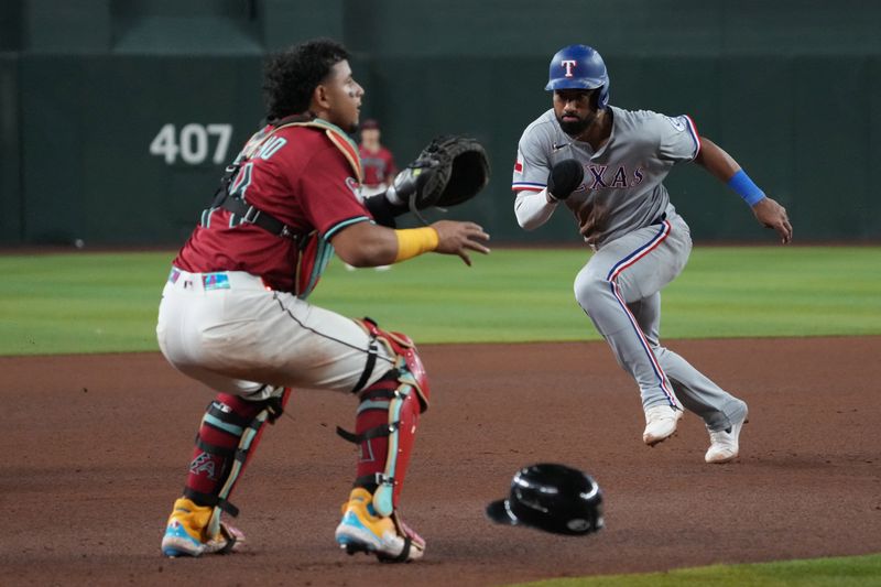 Sep 3, 2025; Phoenix, Arizona, USA; Arizona Diamondbacks catcher Gabriel Moreno (14) tries to tag out Texas Rangers shortstop Ezequiel Duran (20) in the seventh inning at Chase Field. Mandatory Credit: Rick Scuteri-Imagn Images