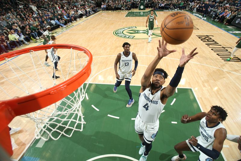 MILWAUKEE, WI - APRIL 3:  Jordan Goodwin #4 of the Memphis Grizzlies rebounds the ball during the game against the Milwaukee Bucks on April 3, 2024 at the Fiserv Forum Center in Milwaukee, Wisconsin. NOTE TO USER: User expressly acknowledges and agrees that, by downloading and or using this Photograph, user is consenting to the terms and conditions of the Getty Images License Agreement. Mandatory Copyright Notice: Copyright 2024 NBAE (Photo by Gary Dineen/NBAE via Getty Images).