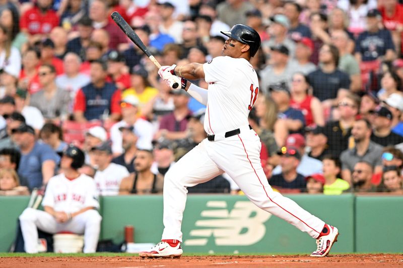 Jun 25, 2024; Boston, Massachusetts, USA; Boston Red Sox third baseman Rafael Devers (11) watches the ball after hitting a solo home run against the Toronto Blue Jays during the second inning at Fenway Park. Mandatory Credit: Brian Fluharty-USA TODAY Sports