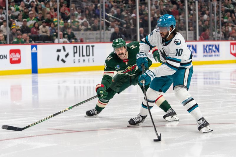 Mar 3, 2024; Saint Paul, Minnesota, USA; San Jose Sharks left wing Anthony Duclair (10) shoots and scores, Minnesota Wild defenseman Jake Middleton (5) on defense in the third period at Xcel Energy Center. Mandatory Credit: Matt Blewett-USA TODAY Sports