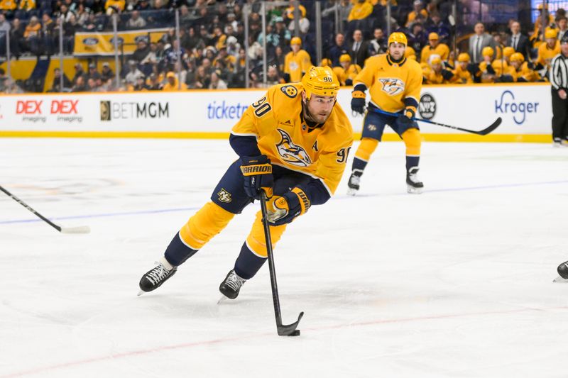 Mar 6, 2025; Nashville, Tennessee, USA;  Nashville Predators center Ryan O'Reilly (90) skates with the puck against the Seattle Kraken during the first period at Bridgestone Arena. Mandatory Credit: Steve Roberts-Imagn Images