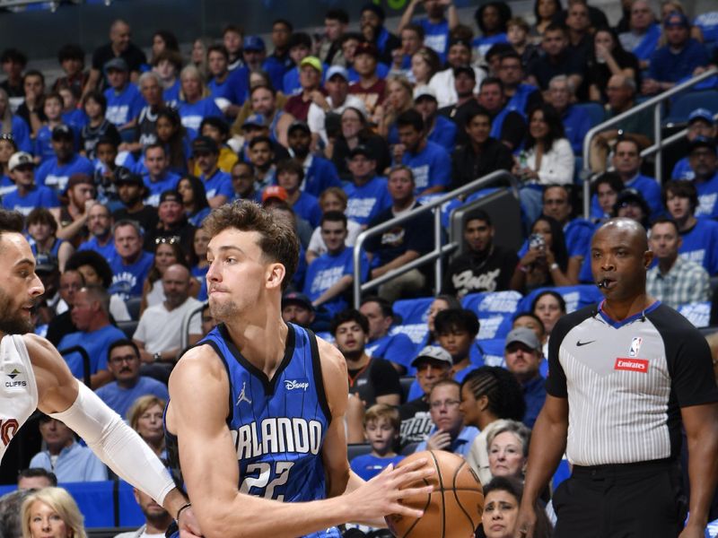 ORLANDO, FL - APRIL 27: Franz Wagner #22 of the Orlando Magic looks to pass the ball during the game against the Cleveland Cavaliers during Round 1 Game 4 of the 2024 NBA Playoffs on April 27, 2024 at the Kia Center in Orlando, Florida. NOTE TO USER: User expressly acknowledges and agrees that, by downloading and or using this photograph, User is consenting to the terms and conditions of the Getty Images License Agreement. Mandatory Copyright Notice: Copyright 2024 NBAE (Photo by Fernando Medina/NBAE via Getty Images)