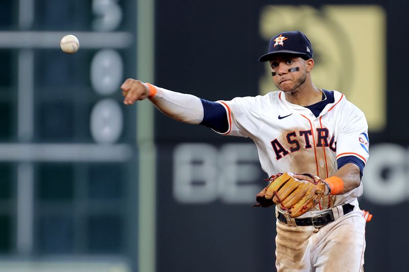 Jun 26, 2024; Houston, Texas, USA; Houston Astros shortstop Jeremy Pena (3) throws a fielded ball to first base for the final out against the Colorado Rockies during the ninth inning at Minute Maid Park. Mandatory Credit: Erik Williams-USA TODAY Sports