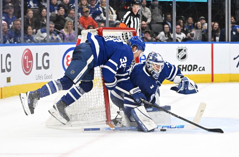 Jan 3, 2023; Toronto, Ontario, CAN; Toronto Maple Leafs goalie Ilya Samsonov (35) makes a save as defenseman Rasmus Sandin (38) crashes into the net in overtime against the St. Louis Blues at Scotiabank Arena. Mandatory Credit: Dan Hamilton-USA TODAY Sports