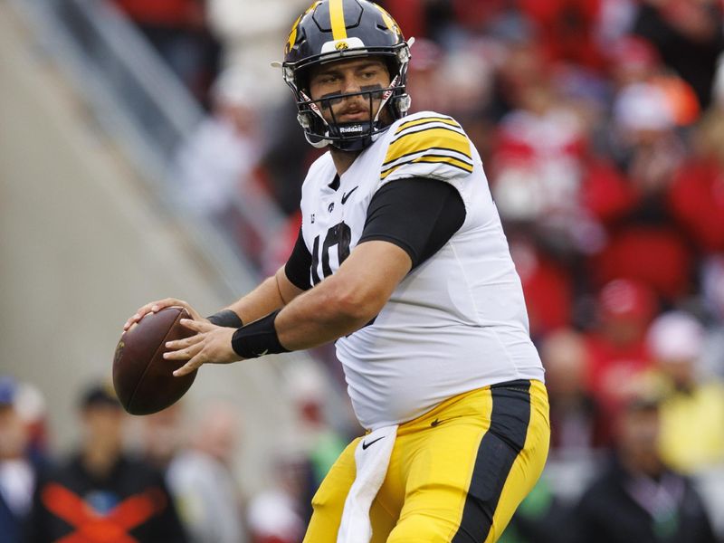 Oct 14, 2023; Madison, Wisconsin, USA;  Iowa Hawkeyes quarterback Deacon Hill (10) throws a pass during the second quarter against the Wisconsin Badgers at Camp Randall Stadium. Mandatory Credit: Jeff Hanisch-USA TODAY Sports