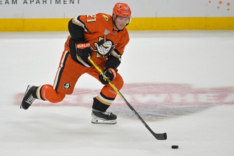 Nov 5, 2024; Anaheim, California, USA; Anaheim Ducks center Isac Lundestrom (21) handles the puck in the first period against the Vancouver Canucks at Honda Center. Mandatory Credit: Jayne Kamin-Oncea-Imagn Images