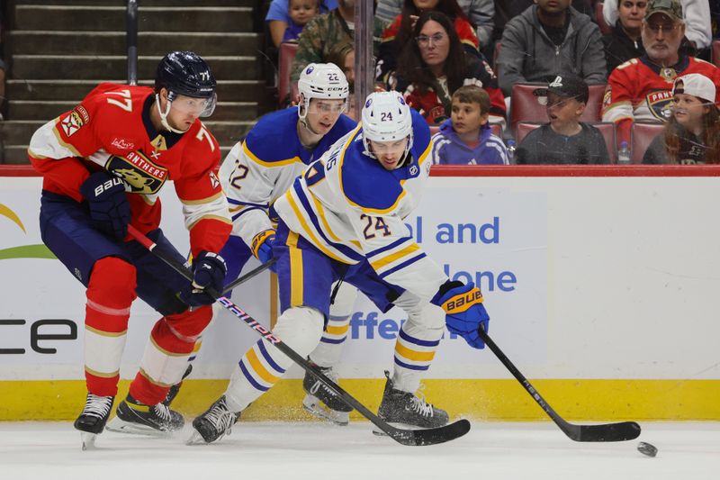 Apr 13, 2024; Sunrise, Florida, USA; Buffalo Sabres center Dylan Cozens (24) protects the puck from Florida Panthers defenseman Niko Mikkola (77) during the first period at Amerant Bank Arena. Mandatory Credit: Sam Navarro-USA TODAY Sports