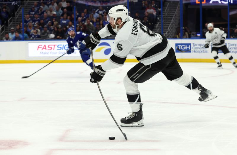 Jan 30, 2025; Tampa, Florida, USA; Los Angeles Kings defenseman Joel Edmundson (6) skates with the puck against the Tampa Bay Lightning during the third period at Amalie Arena. Mandatory Credit: Kim Klement Neitzel-Imagn Images
