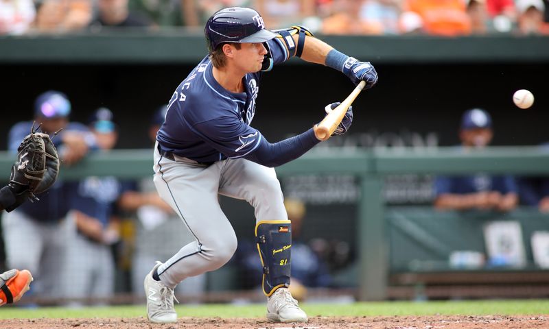 Jun 2, 2024; Baltimore, Maryland, USA; Tampa Bay Rays outfielder Jonny DeLuca (21) attempts to lay down a bunt during the sixth inning against the Baltimore Orioles at Oriole Park at Camden Yards. Mandatory Credit: Daniel Kucin Jr.-USA TODAY Sports