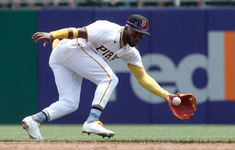 May 24, 2023; Pittsburgh, Pennsylvania, USA; Pittsburgh Pirates shortstop Rodolfo Castro (14) fields a ground ball for an out against Texas Rangers center fielder Leody Taveras (not pictured) during the fifth inning at PNC Park. Mandatory Credit: Charles LeClaire-USA TODAY Sports