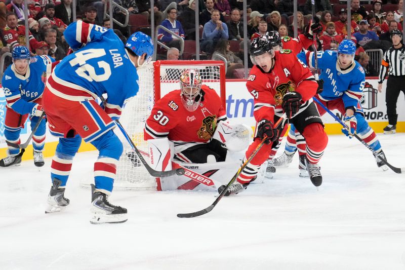 Dec 10, 2025; Chicago, Illinois, USA; New York Rangers center Noah Laba (42) shoots the puck on Chicago Blackhawks goaltender Spencer Knight (30) during the third period at United Center. Mandatory Credit: David Banks-Imagn Images