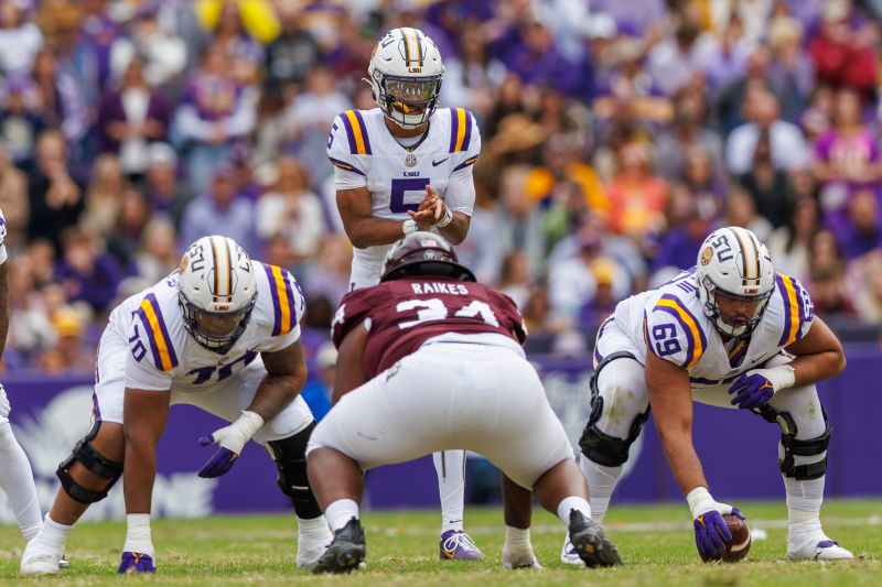 Nov 25, 2023; Baton Rouge, Louisiana, USA;  LSU Tigers quarterback Jayden Daniels (5) calls for the ball against Texas A&M Aggies defensive lineman Isaiah Raikes (34) during the second half at Tiger Stadium. Mandatory Credit: Stephen Lew-USA TODAY Sports