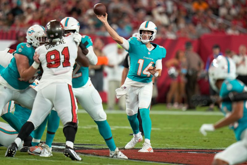 Miami Dolphins quarterback Mike White (14) aims a pass during the first half of a pre season NFL football game against the Tampa Bay Buccaneers , Friday, Aug. 23, 2024, in Tampa, Fla. (AP Photo/Chris O'Meara)