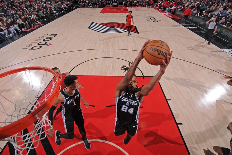 PORTLAND, OR - DECEMBER 13: Devin Vassell #24 of the San Antonio Spurs grabs the rebound during the game against the Portland Trail Blazers on December 13, 2024 at the Moda Center Arena in Portland, Oregon. NOTE TO USER: User expressly acknowledges and agrees that, by downloading and or using this photograph, user is consenting to the terms and conditions of the Getty Images License Agreement. Mandatory Copyright Notice: Copyright 2024 NBAE (Photo by Cameron Browne/NBAE via Getty Images)