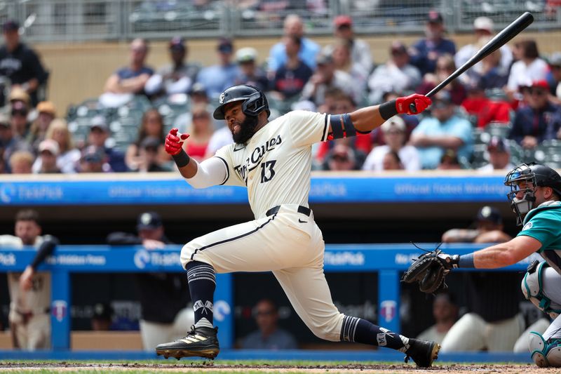 May 9, 2024; Minneapolis, Minnesota, USA; Minnesota Twins Manuel Margot (13) hits a three RBI double against the Seattle Mariners during the first inning at Target Field. Mandatory Credit: Matt Krohn-USA TODAY Sports