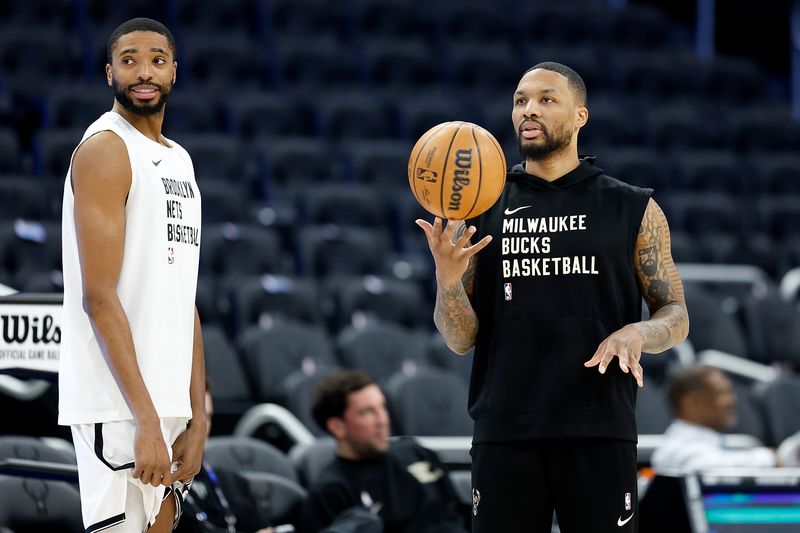 MILWAUKEE, WISCONSIN - MARCH 21: Damian Lillard #0 of the Milwaukee Bucks talks with Mikal Bridges #1 of the Brooklyn Nets before the game at Fiserv Forum on March 21, 2024 in Milwaukee, Wisconsin. NOTE TO USER: User expressly acknowledges and agrees that, by downloading and or using this photograph, User is consenting to the terms and conditions of the Getty Images License Agreement. (Photo by John Fisher/Getty Images)