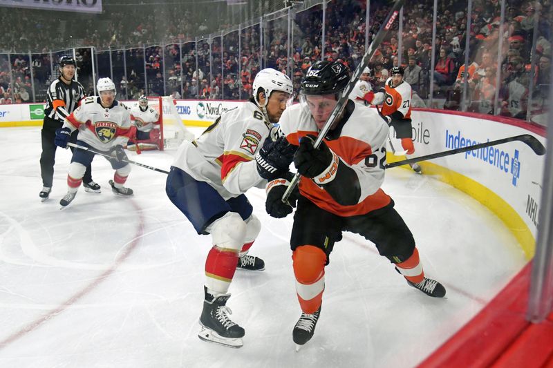 Mar 24, 2024; Philadelphia, Pennsylvania, USA; Philadelphia Flyers right wing Olle Lycksell (62) and Florida Panthers defenseman Brandon Montour (62) battle for the puck during the third period at Wells Fargo Center. Mandatory Credit: Eric Hartline-USA TODAY Sports