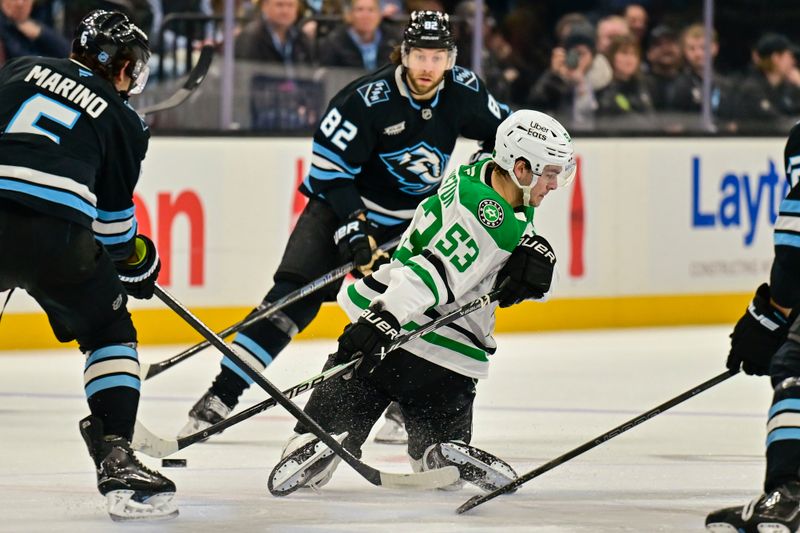 Jan 31, 2026; Salt Lake City, Utah, USA; Dallas Stars center Wyatt Johnston (53) makes a pass behind the back during first period around Utah Mammoth defenseman John Marino (6) at Delta Center. Mandatory Credit: Peter Creveling-Imagn Images