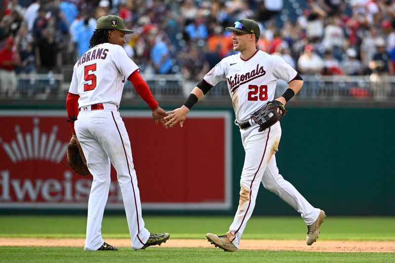 May 20, 2023; Washington, District of Columbia, USA; Washington Nationals right fielder Lane Thomas (28) and shortstop CJ Abrams (5) celebrate after the game against the Detroit Tigers at Nationals Park. Mandatory Credit: Brad Mills-USA TODAY Sports