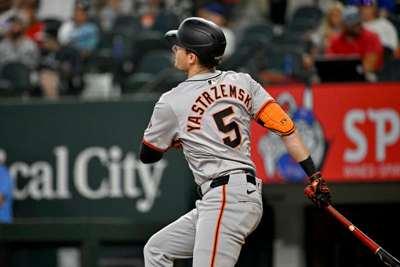 Jun 8, 2024; Arlington, Texas, USA; San Francisco Giants right fielder Mike Yastrzemski (5) watches a ball go down the foul line during the game between the Texas Rangers and the Giants at Globe Life Field. Mandatory Credit: Jerome Miron-USA TODAY Sports