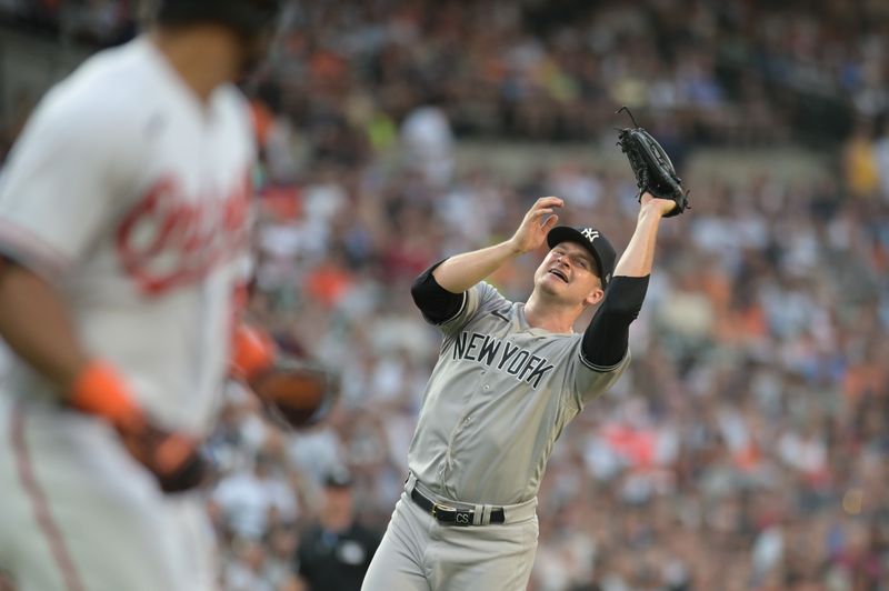 Jul 29, 2023; Baltimore, Maryland, USA;  New York Yankees starting pitcher Clarke Schmidt (36) catches Baltimore Orioles right fielder Anthony Santander (25) pop fly during the first inning at Oriole Park at Camden Yards. Mandatory Credit: Tommy Gilligan-USA TODAY Sports