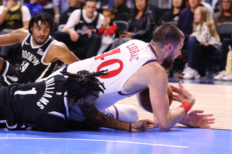 OCEANSIDE, CALIFORNIA - OCTOBER 08: Ziaire Williams #1 of the Brooklyn Nets and Ivica Zubac #40 of the Los Angeles Clippers fight for a loose ball in the second quarter of the preseason game at Frontwave Arena on October 08, 2024 in Oceanside, California. NOTE TO USER: User expressly acknowledges and agrees that, by downloading and or using this photograph, User is consenting to the terms and conditions of the Getty Images License Agreement. (Photo by Joe Scarnici/Getty Images)