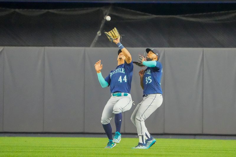 Jun 22, 2023; Bronx, New York, USA; Seattle Mariners center fielder Julio Rodriguez (44) catches a fly ball hit by New York Yankees right fielder Giancarlo Stanton (not pictured) along side of Seattle Mariners right fielder Teoscar Hernandez (35) during the fourth inning at Yankee Stadium. Mandatory Credit: Gregory Fisher-USA TODAY Sports