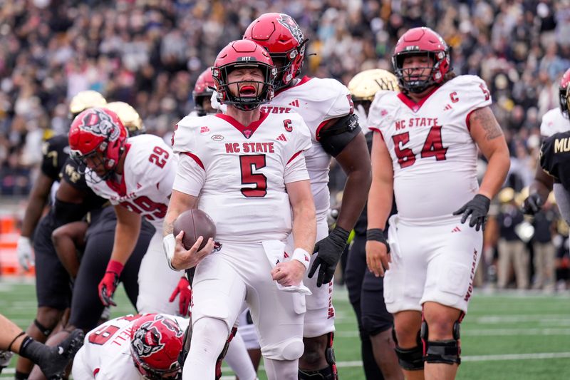 Nov 11, 2023; Winston-Salem, North Carolina, USA;  North Carolina State Wolfpack quarterback Brennan Armstrong (5) reacts to his scoring run against the Wake Forest Demon Deacons during the first half at Allegacy Federal Credit Union Stadium. Mandatory Credit: Jim Dedmon-USA TODAY Sports