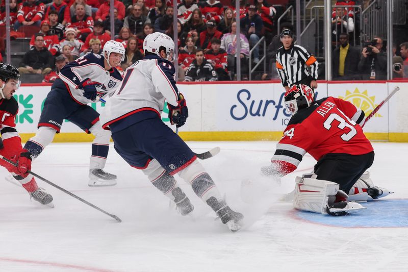 Dec 1, 2025; Newark, New Jersey, USA; New Jersey Devils goaltender Jake Allen (34) makes a save against the Columbus Blue Jackets during the first period at Prudential Center. Mandatory Credit: Ed Mulholland-Imagn Images