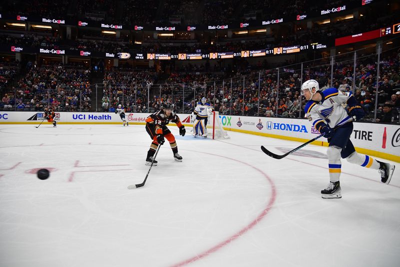 Apr 7, 2024; Anaheim, California, USA; St. Louis Blues defenseman Colton Parayko (55) clears the puck against Anaheim Ducks center Nikita Nesterenko (62) during the second period at Honda Center. Mandatory Credit: Gary A. Vasquez-USA TODAY Sports