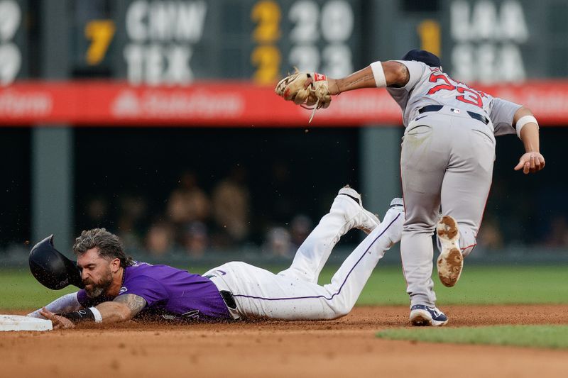 Jul 22, 2024; Denver, Colorado, USA; Colorado Rockies right fielder Jake Cave (11) is tagged out attempting to steal second against Boston Red Sox second baseman Jamie Westbrook (73) in the fifth inning at Coors Field. Mandatory Credit: Isaiah J. Downing-USA TODAY Sports