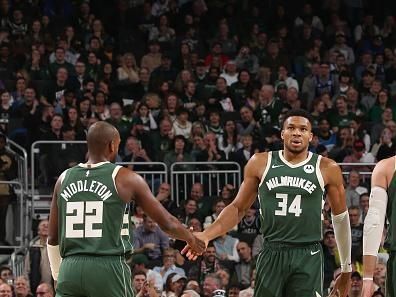 MILWAUKEE, WI - DECEMBER 21:  Khris Middleton #22 high fives Giannis Antetokounmpo #34 of the Milwaukee Bucks during the game against the Orlando Magic on December 21, 2023 at the Fiserv Forum Center in Milwaukee, Wisconsin. NOTE TO USER: User expressly acknowledges and agrees that, by downloading and or using this Photograph, user is consenting to the terms and conditions of the Getty Images License Agreement. Mandatory Copyright Notice: Copyright 2023 NBAE (Photo by Gary Dineen/NBAE via Getty Images).