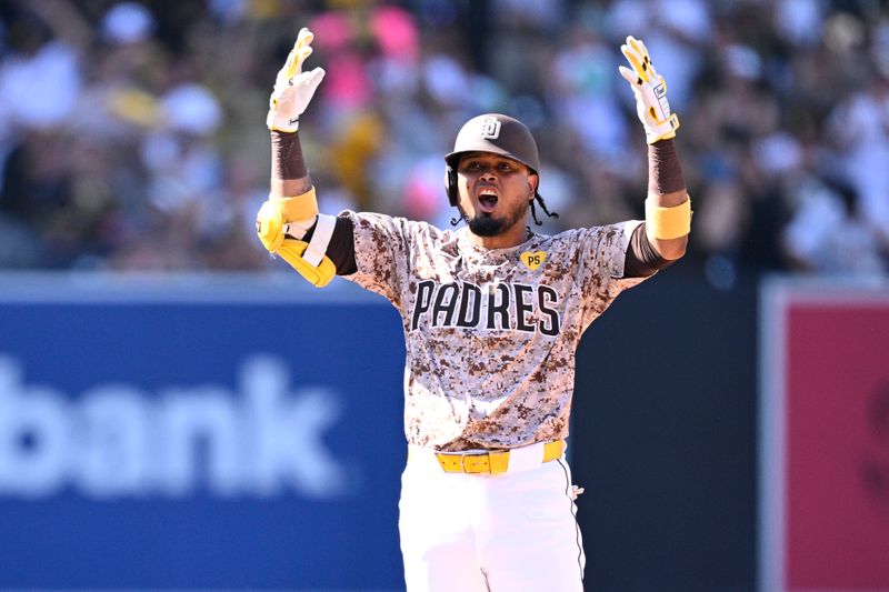 Sep 22, 2024; San Diego, California, USA; San Diego Padres first baseman Luis Arraez (4) celebrates after hitting an RBI double against the Chicago White Sox during the eighth inning at Petco Park. Mandatory Credit: Orlando Ramirez-Imagn Images