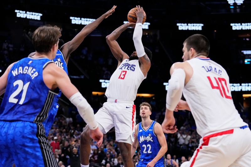 ORLANDO, FLORIDA - MARCH 29: Paul George #13 of the Los Angeles Clippers goes up for a shot against Jonathan Isaac #1 of the Orlando Magic during the fourth quarter at Kia Center on March 29, 2024 in Orlando, Florida. NOTE TO USER: User expressly acknowledges and agrees that, by downloading and or using this photograph, User is consenting to the terms and conditions of the Getty Images License Agreement. (Photo by Rich Storry/Getty Images)