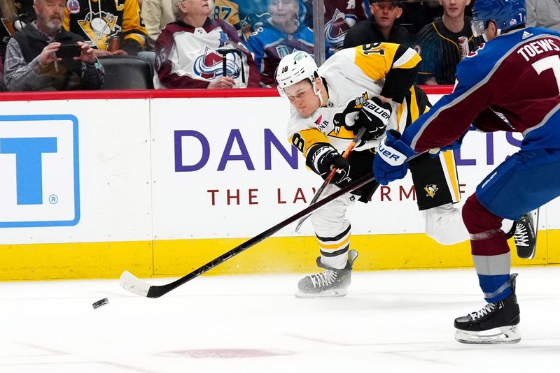 Mar 24, 2024; Denver, Colorado, USA; Pittsburgh Penguins right wing Jesse Puljujarvi (18) shoots the puck in the first period against the Colorado Avalanche at Ball Arena. Mandatory Credit: Ron Chenoy-USA TODAY Sports