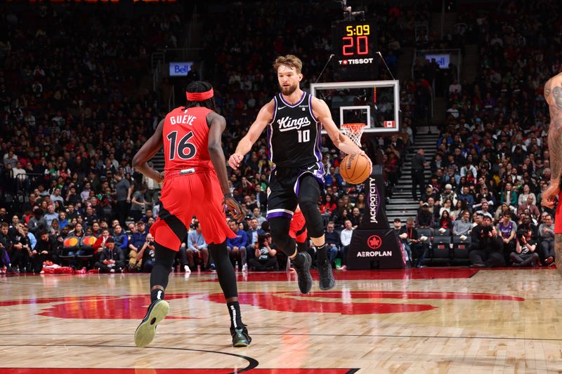 TORONTO, CANADA - MARCH 20: Domantas Sabonis #10 of the Sacramento Kings dribbles the ball during the game against the Toronto Raptors on March 20, 2024 at the Scotiabank Arena in Toronto, Ontario, Canada.  NOTE TO USER: User expressly acknowledges and agrees that, by downloading and or using this Photograph, user is consenting to the terms and conditions of the Getty Images License Agreement.  Mandatory Copyright Notice: Copyright 2024 NBAE (Photo by Vaughn Ridley/NBAE via Getty Images)