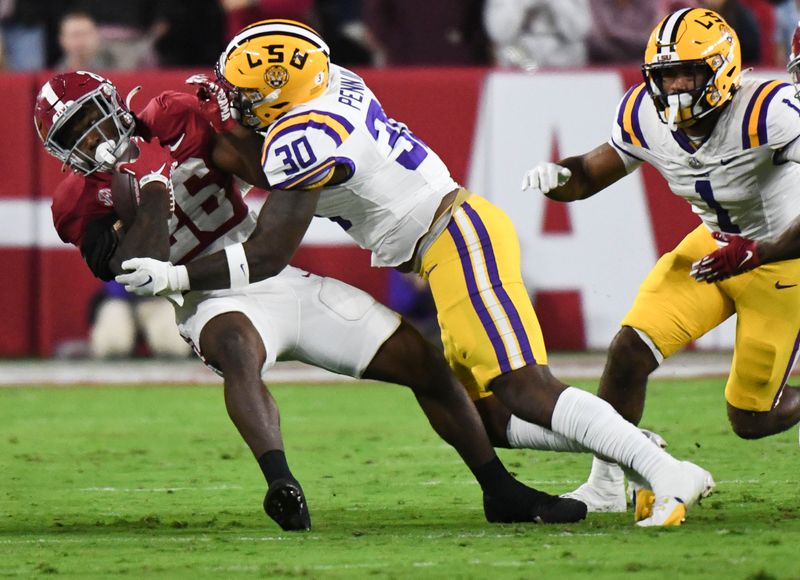 Nov 4, 2023; Tuscaloosa, Alabama, USA;  Alabama Crimson Tide running back Jam Miller (26) is brought down by LSU Tigers linebacker Greg Penn III (30) at Bryant-Denny Stadium. Mandatory Credit: Gary Cosby Jr.-USA TODAY Sports