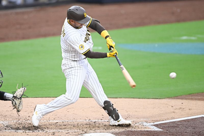 May 26, 2025; San Diego, California, USA; San Diego Padres second baseman Jose Iglesias (7) hits an RBI double during the fourth inning against the Miami Marlins at Petco Park. Mandatory Credit: Denis Poroy-Imagn Images