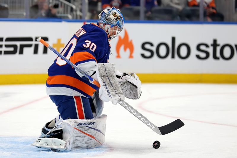 Dec 5, 2024; Elmont, New York, USA; New York Islanders goaltender Ilya Sorokin (30) plays the puck against the Seattle Kraken during the first period at UBS Arena. Mandatory Credit: Brad Penner-Imagn Images