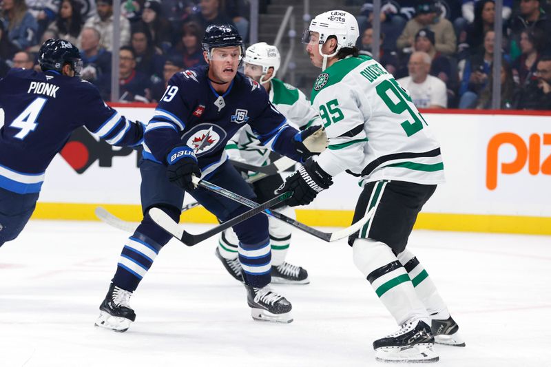 Oct 9, 2025; Winnipeg, Manitoba, CAN; Winnipeg Jets centre Jonathan Toews (19) checks Dallas Stars center Matt Duchene (95) in the first period at Canada Life Centre. Mandatory Credit: James Carey Lauder-Imagn Images