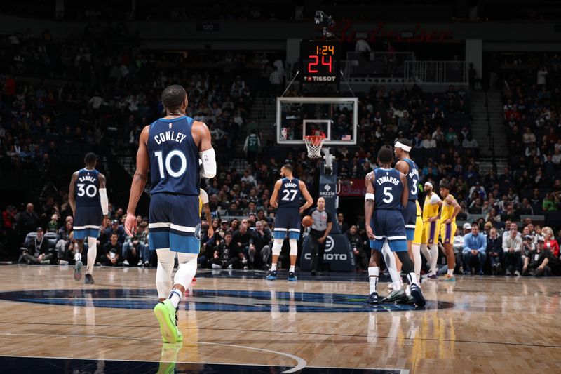 MINNEAPOLIS, MN -  DECEMBER 13:  Mike Conley #10 of the Minnesota Timberwolves looks on during the game against the Los Angeles Lakers on December 13, 2024 at Target Center in Minneapolis, Minnesota. NOTE TO USER: User expressly acknowledges and agrees that, by downloading and or using this Photograph, user is consenting to the terms and conditions of the Getty Images License Agreement. Mandatory Copyright Notice: Copyright 2024 NBAE (Photo by David Sherman/NBAE via Getty Images)