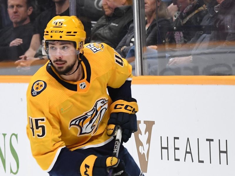 Mar 5, 2024; Nashville, Tennessee, USA; Nashville Predators defenseman Alexandre Carrier (45) handles the puck during the second period against the Montreal Canadiens at Bridgestone Arena. Mandatory Credit: Christopher Hanewinckel-USA TODAY Sports