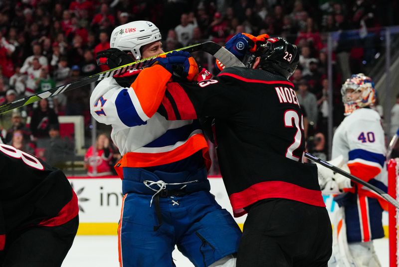 Apr 22, 2024; Raleigh, North Carolina, USA; Carolina Hurricanes right wing Stefan Noesen (23) and New York Islanders left wing Matt Martin (17) battle during the third period in game two of the first round of the 2024 Stanley Cup Playoffs at PNC Arena. Mandatory Credit: James Guillory-USA TODAY Sports