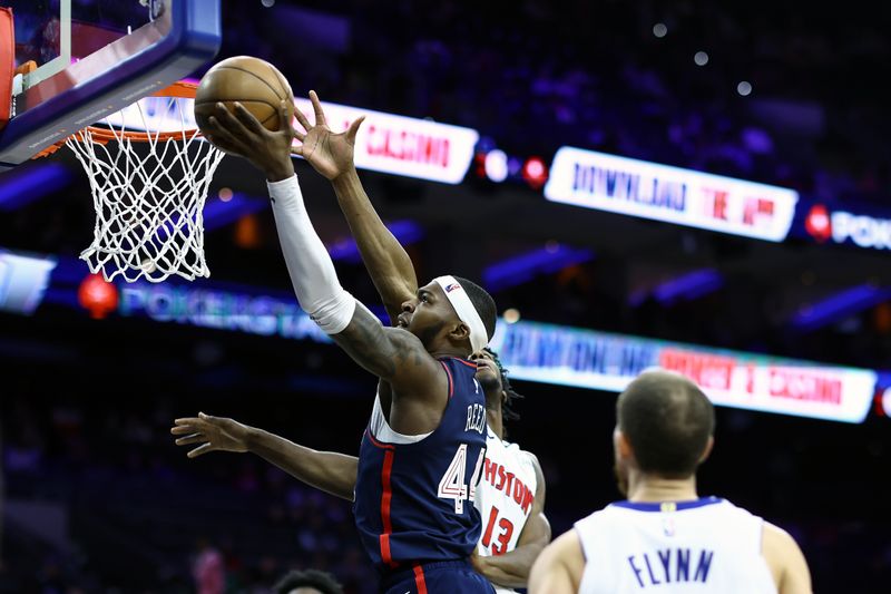 PHILADELPHIA, PENNSYLVANIA - APRIL 09: Paul Reed #44 of the Philadelphia 76ers shoots a lay up past James Wiseman #13 of the Detroit Pistons during the fourth quarter at the Wells Fargo Center on April 09, 2024 in Philadelphia, Pennsylvania. (Photo by Tim Nwachukwu/Getty Images)