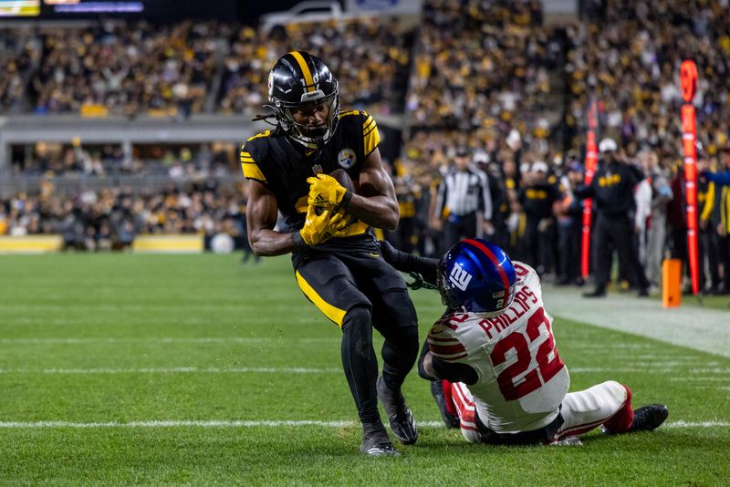 Pittsburgh Steelers wide receiver Calvin Austin III (19) catches a 29 yard touchdown in front of New York Giants cornerback Dru Phillips (22) during an NFL football game, Monday, Oct. 28, 2024, in Pittsburgh. (AP Photo/Matt Durisko)