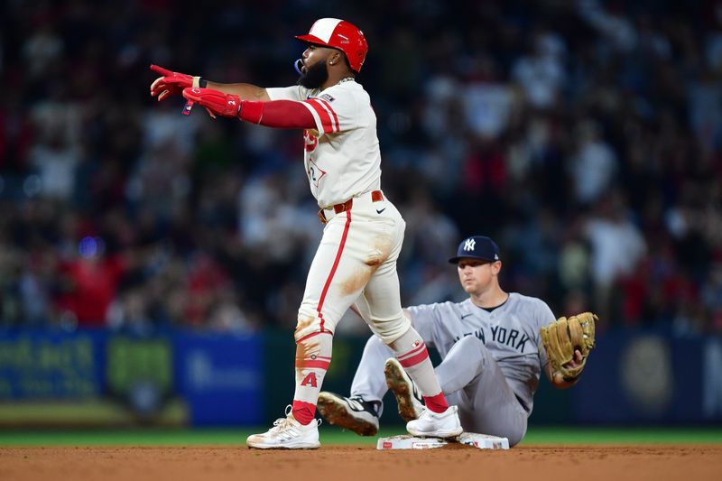 May 27, 2025; Anaheim, California, USA; Los Angeles Angels second baseman Luis Rengifo (2) calls for video replay after reaching second against New York Yankees second baseman DJ LeMahieu (26) during the ninth inning at Angel Stadium.  The call resulted in an out.  Mandatory Credit: Gary A. Vasquez-Imagn Images