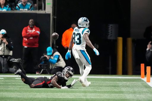 Atlanta Falcons running back Tyler Allgeier (25) and Carolina Panthers wide receiver David Moore (83) are seen after a play during the second half of an NFL football game against the Carolina Panthers, Sunday, Jan. 5, 2025, in Atlanta. (AP Photo/Mike Stewart)