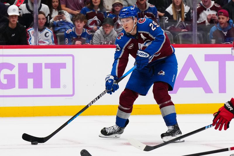 Nov 9, 2024; Denver, Colorado, USA; Colorado Avalanche center Nathan MacKinnon (29) prepares to pass the puck in the second period against the Carolina Hurricanes at Ball Arena. Mandatory Credit: Ron Chenoy-Imagn Images