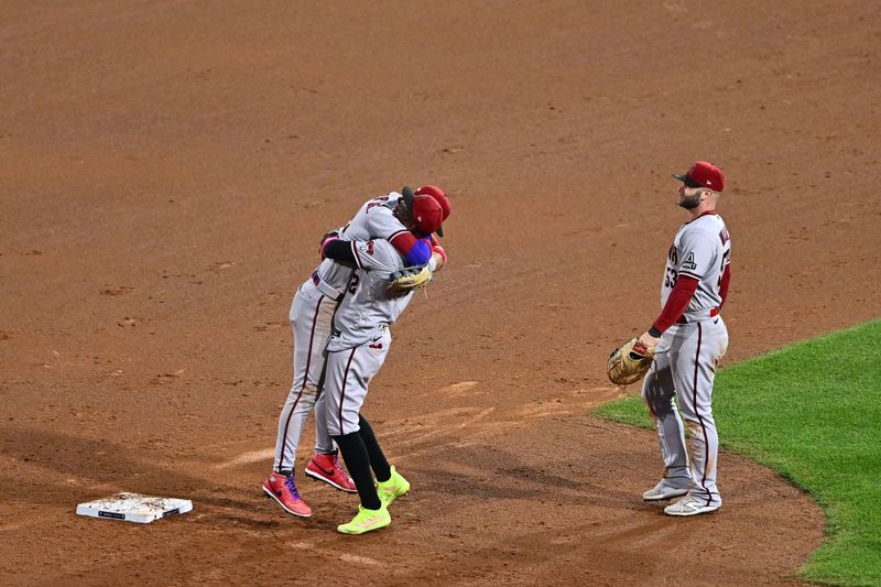 Oct 24, 2023; Philadelphia, Pennsylvania, USA; Arizona Diamondbacks left fielder Lourdes Gurriel Jr. (12) and shortstop Geraldo Perdomo (2) react after defeating the Philadelphia Phillies in game seven of the NLCS for the 2023 MLB playoffs at Citizens Bank Park. Mandatory Credit: Kyle Ross-USA TODAY Sports